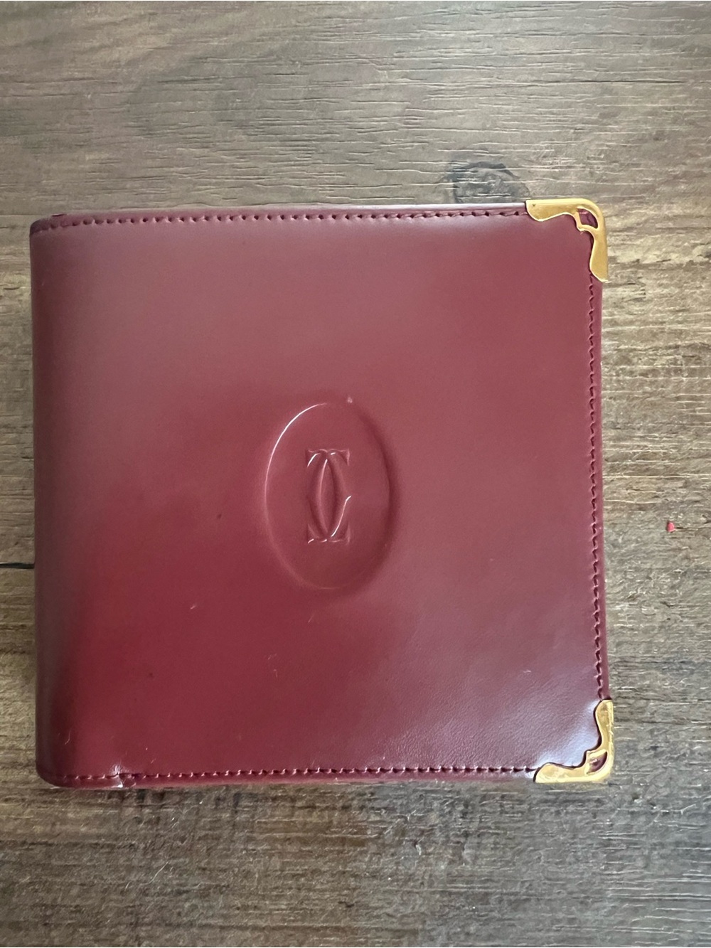 Cartier Burgundy Leather Bi-Fold Wallet with Gold Corner Accents